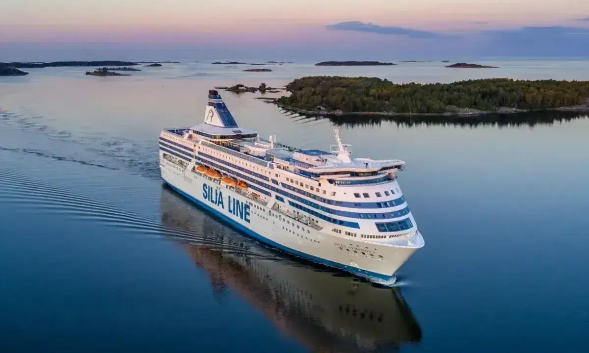 Duży prom Silja Line płynie po spokojnym morzu, tworząc fale. To podróż między Tallinem a Helsinkami.
