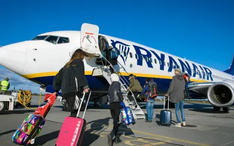 Ludzie wsiadają do samolotu Ryanair z bagażami. Zastanawiasz się, czy można zwrócić bilety Ryanair?