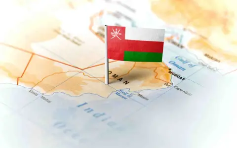 Flaga Omanu wbita w mapę, wskazująca gdzie leży Oman, nad Zatoką Omańską, w pobliżu Maskatu.